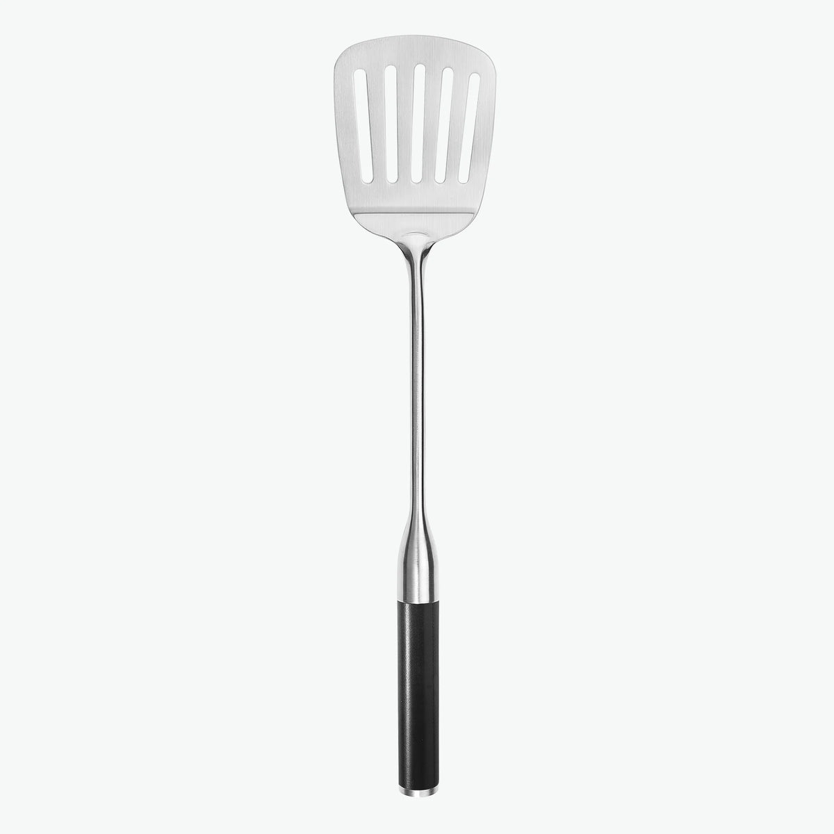 Stekspade med hål i rostfritt stål och handtag i G-10, sedd framifrån