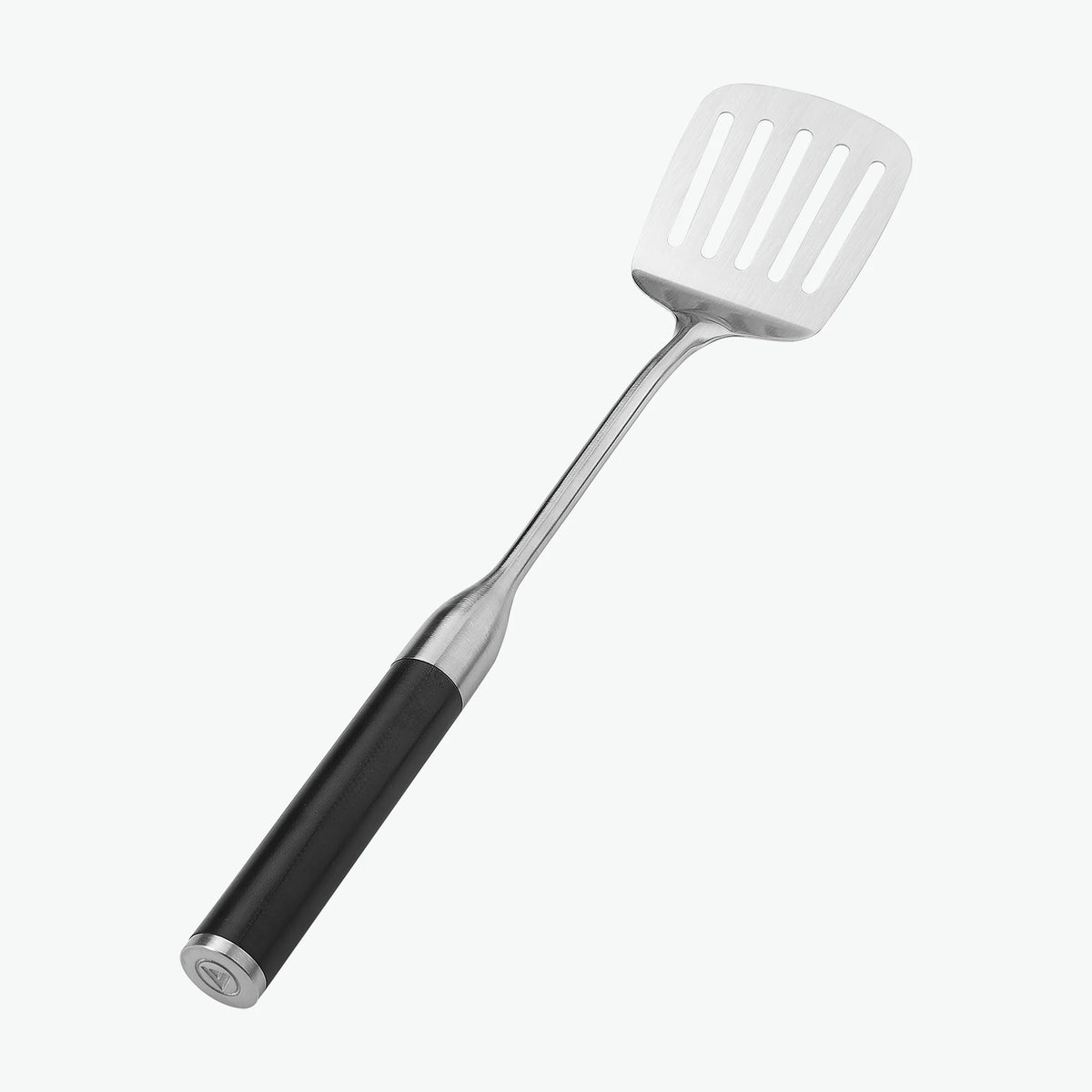 Stekspade med hål och handtag i G-10, sedd snett